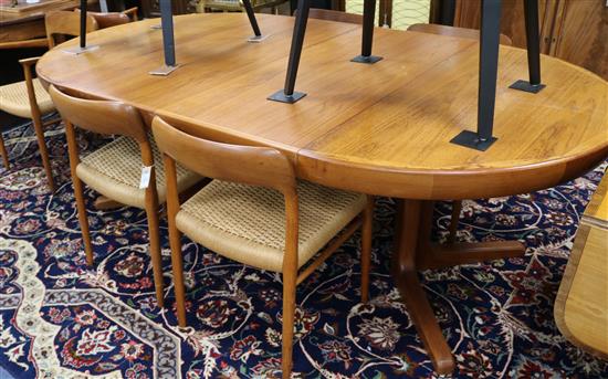 Moller Models, Denmark. A set of eight teak dining chairs (two with arms) and a teak extending circular dining table